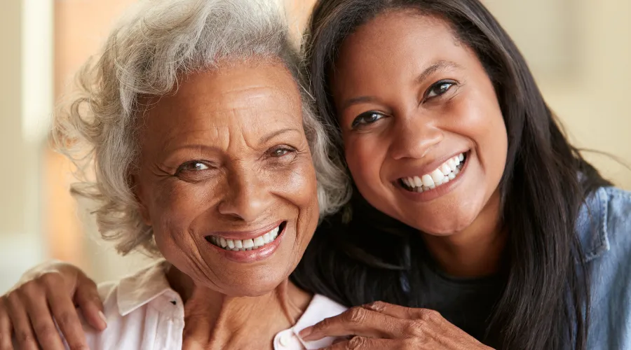 Elder mother and adult daughter smiling together, symbolizing peace of mind through long-term care and Medicaid planning with an Elder Law Lawyer