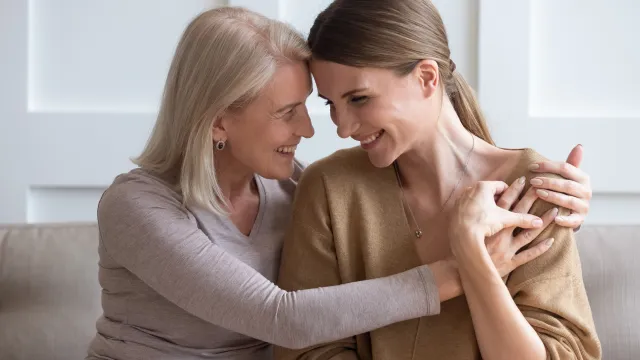 Adult daughter embracing her mother after learning their Florida home will avoid probate through a Lady Bird Deed