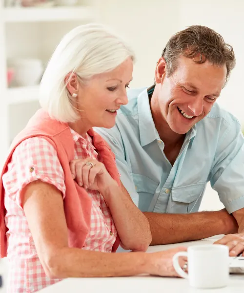 Elder law attorney discussing estate planning documents with senior client in a professional office