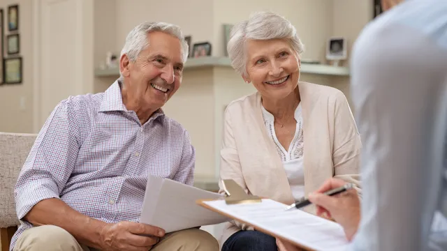 Older Florida couple meeting with an elder law attorney to plan for Medicaid eligibility and long-term care using a Lady Bird Deed