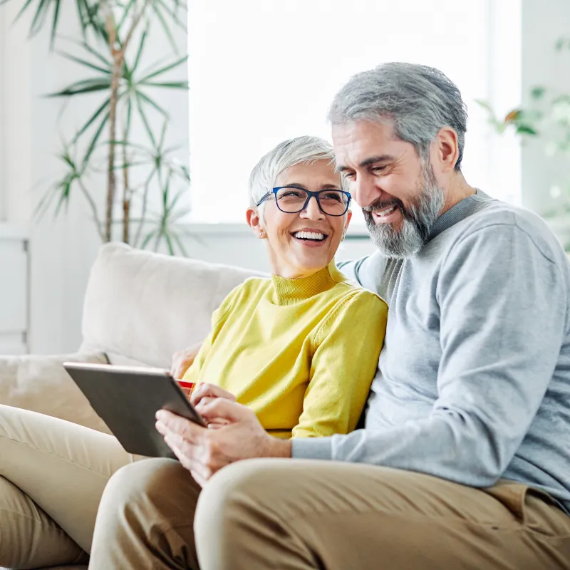 Senior couple reviewing Health Care Directives and POA paperwork together at home in Florida