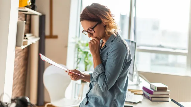 Woman reviewing health care directive paperwork while planning medical decision-making in Florida
